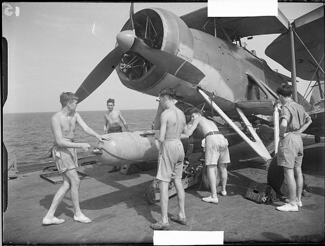 Torpedo loaded under a Swordfish onboar HMS Illustrious