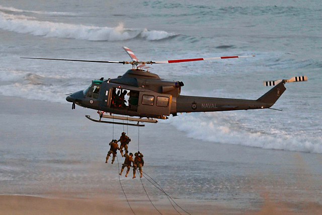 Bell AB-212 Navy helicopter picking up Marines during training