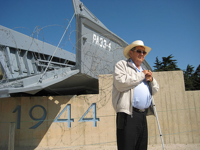 A veteran od D-Day revisiting a static example at Utah Beach in the 1990s